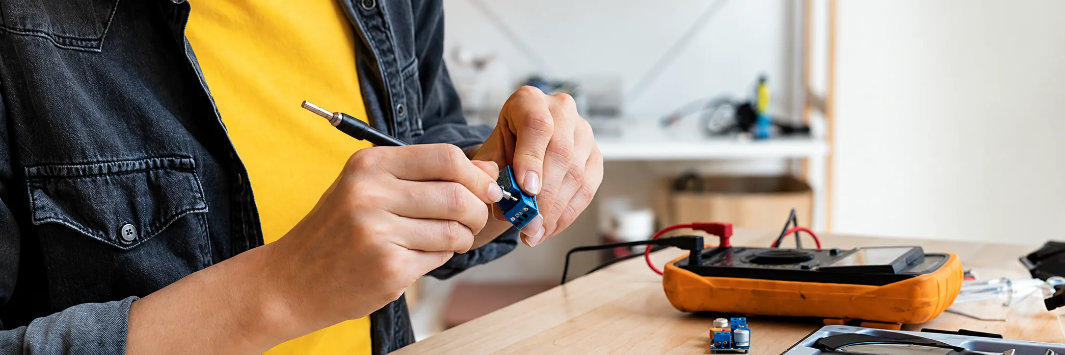 Inventor assembling a prototype circuit at a workshop bench